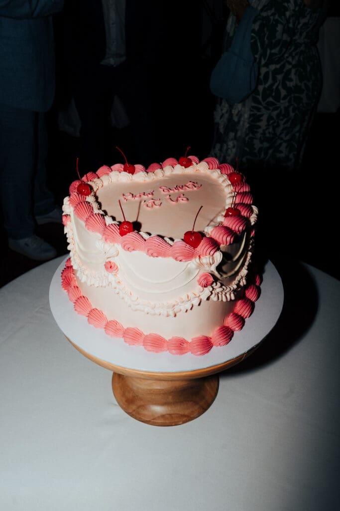 Alternative retro heart shaped wedding cake with piping and cherries