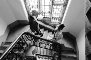 Bride and Groom walking down stairs at winchester registry office