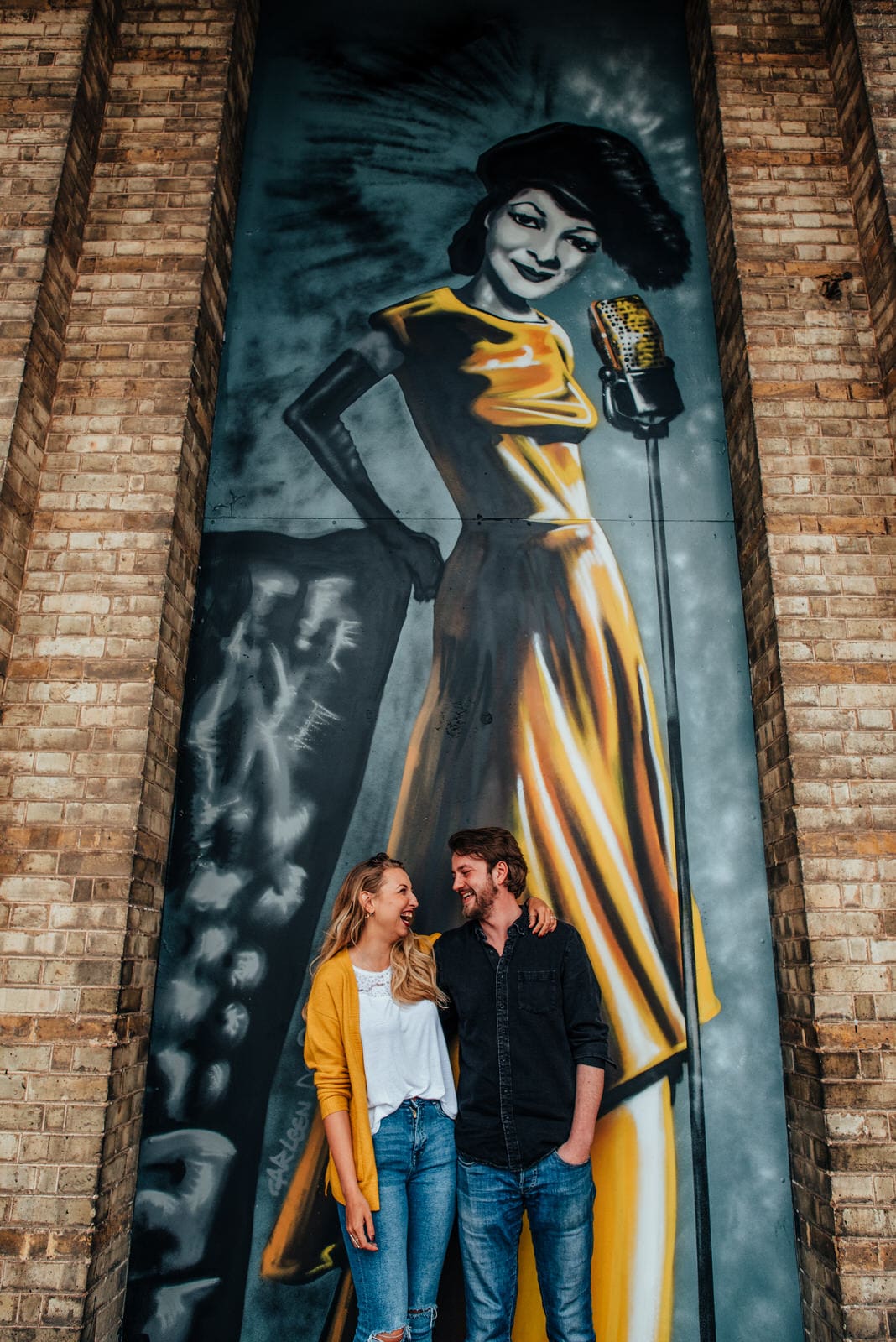 Couple sat in front of a mural at Alexander Palace, alternative wedding photography.